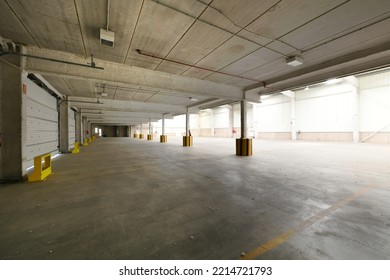 Empty Industrial Building With Concrete Floors, Precast Concrete Rib Beams, Metal Sliding Doors