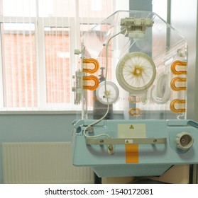 Empty Infant Incubator In An Hospital Room. Closeup View Of Nursery Incubator For Newborn. Box For Carrying Premature Babies.