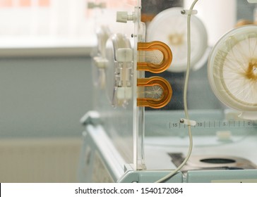 Empty Infant Incubator In An Hospital Room. Closeup View Of Nursery Incubator For Newborn. Box For Carrying Premature Babies.