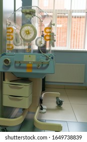 Empty Infant Incubator In An Hospital Room. Closeup View Of Nursery Incubator For Newborn. Box For Carrying Premature Babies.