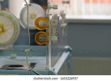 Empty Infant Incubator In An Hospital Room. Closeup View Of Nursery Incubator For Newborn. Box For Carrying Premature Babies.