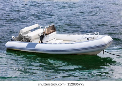 Empty inflatable boat in choppy water
