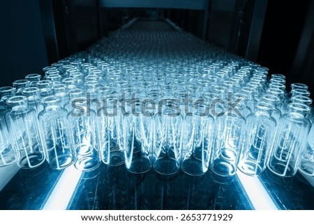 empty injection vials pharma grade injection glass vials to be filled with medical chemical drugs in an injection manufacturing line inside a healthcare pharma industry factory	
