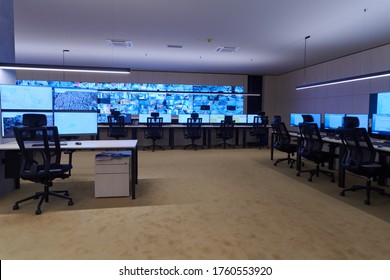 Empty interior of big modern security system control room, workstation with multiple displays, monitoring room with at security data center  Empty office, desk, and chairs at a main CCT security data 