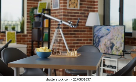 Empty Interior With Chess Board Game And Chips On Table, Space Prepared For Fun Get Together With Friends. No People In Living Room Decorated With Leisure Activity Games, To Enjoy Gathering.