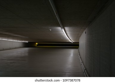 Empty interior of low height pure concrete tunnel and light tube