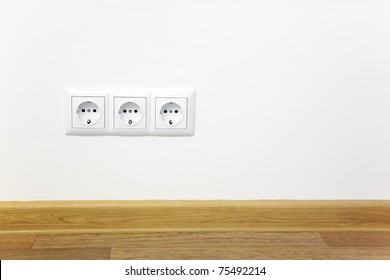 Empty Interior  White Wall  With Power Outlet / Wooden Floor