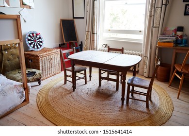 Empty Interior Of Young Boys Bedroom With Table And Storage