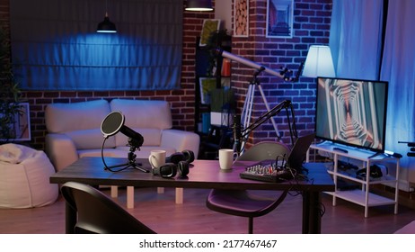 Empty Internet Online Radio Setup With Headphones For Producing Podcasts And Audio Recording Professional Mixer On Desk For Social Media. Nobody In Podcast Home Studio With Microphone Boom Arm.