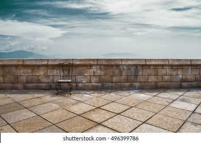 Empty Iron Chair On The Stone Roof Top
