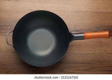 Empty Iron Wok On Wooden Table, Top View. Chinese Cookware