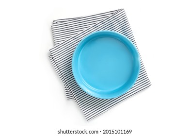 Empty Isolated Blue Plate With Strip Napkin On White Bakground. Food Background For Menu, Recipe. Table Setting. Flatlay, Top View. Mockup For Restaurant Dish