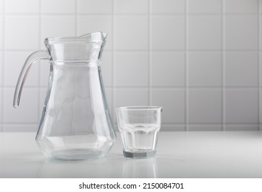 An Empty Jug And A Glass On The Table 