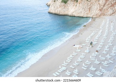 Empty Kaputas Beach At Kaş Antalya. Empty Beach Background With Sea, Sand, Sun Bed And Rocks. One Of The Most Famous Beach In Turkey. No People At Beach Concept.