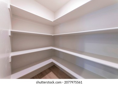 Empty Kitchen Pantry Interior With White Shelving Units