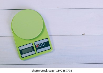 Empty Kitchen Scales On A Wooden Table