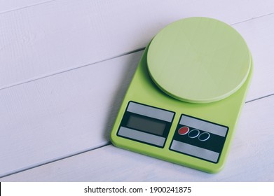 Empty Kitchen Scales On A Wooden Table