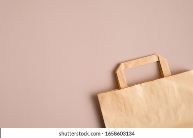 Empty Kraft Paper Bag On Brown Background With Copy Space.  Packaging Template Mockup