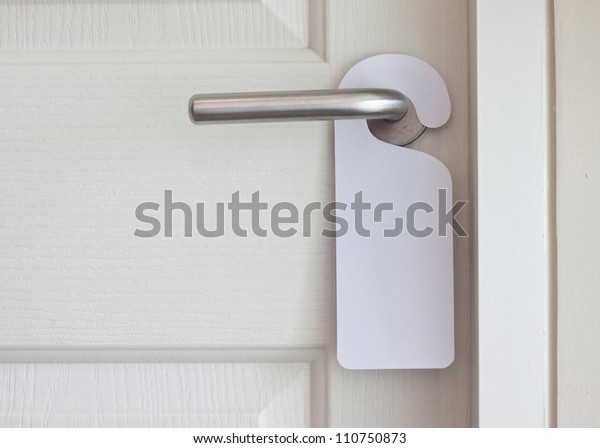 Empty label on a\
door handle for your text