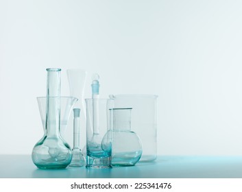 empty laboratory glassware on table with white background. high key image