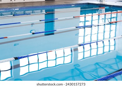 Empty lanes in a serene indoor swimming pool await swimmers. Calm water reflects the tranquility of a facility designed for sport and leisure. - Powered by Shutterstock