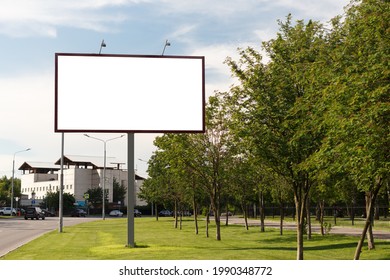 Empty Large Horizontal Billboard On The Lawn In The City Next To The Trees. Mock Up.