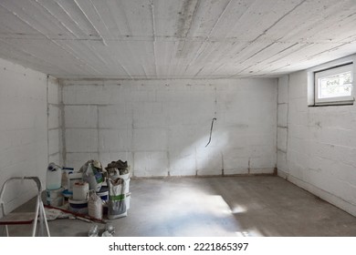 Empty Large Room In Basement Of Family House Before Renovation