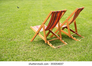 Empty Lawn Chairs On Grass In The Park