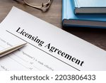 Empty licensing agreement application form and pen.