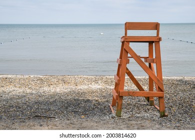 Empty Lifeguard Chair On Quiet Lakeshore Beach