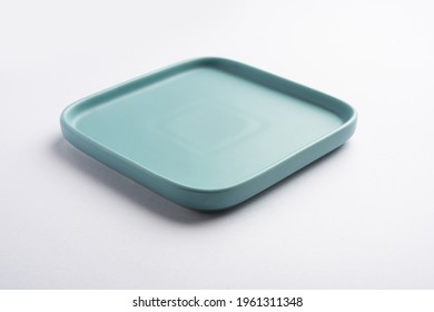 Empty Light Green Or Blue Ceramic Square Plate Isolated On White Background