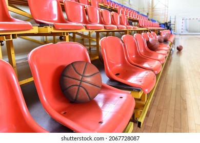 Empty Line Of Stadium Chairs With Basketball Ball.