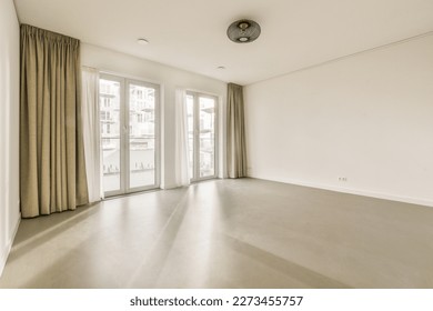an empty living room with sliding glass doors and floor to the right, there is no one person in it