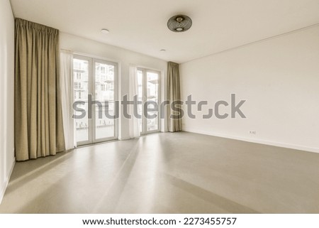 an empty living room with sliding glass doors and floor to the right, there is no one person in it