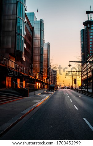 Empty lonely street view of downtown district with golden warm sunset light with buisness buildings. Historic and famous harbour district Speicherstadt and modern Hafencity  in Hamburg, Europe
