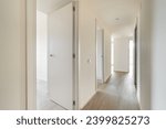 Empty long corridor with open doors to different rooms