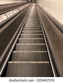 Empty Long Escalator Moving Up and Down to/from The Metro or Underground Train Station at Night used as Template for Mock up or Background Texture