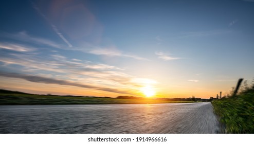 Empty Long Mountain Road To The Horizon On A Sunny Summer Day At Bright Sunset