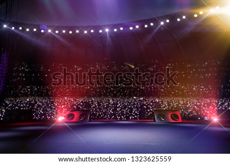 Empty main stage big music festival. Aroun full stadium of spectators. fans are holding flashlights