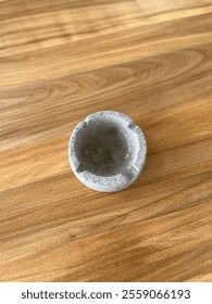 Empty marble ashtray on the table. Looked from above.