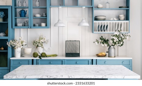Empty marble kitchen island with clean surface in blue vintage kinchen in provence style. Dining table against blurred stylish furniture with drawers and kitchenware. Pendant lights hanging above. - Shutterstock ID 2331633201