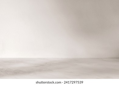 Empty marble neutral taupe tabletop and white textured wall background with soft abstract natural sun light shadows, product podium template.