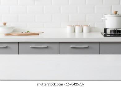 Empty Marble Stone Table Top And Blurred View Of Kitchen Bench Background.