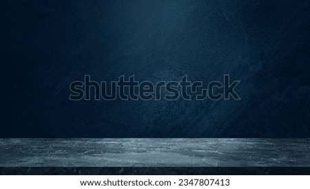 empty marble table at foreground and cement stone at background with blue light from above for product displayed in rustic mood. blue backdrop. abstract background for product stand for advertising.