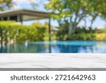 Empty marble table top with blur outdoor swimming pool in tropical resort hotel summer background