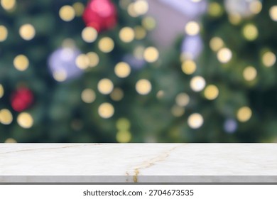 Empty marble table top with blur Christmas tree with bokeh light background