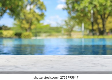 Empty marble table top with blur outdoor swimming pool in tropical resort hotel summer background