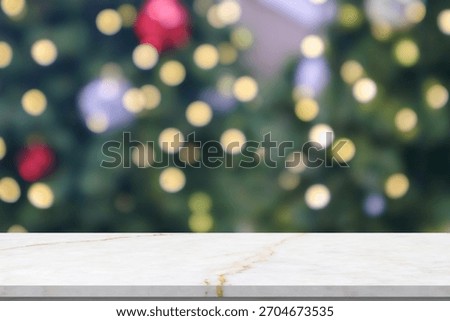 Empty marble table top with blur Christmas tree with bokeh light background