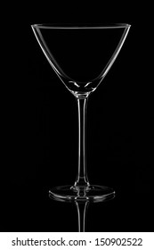 An Empty Martini Glass On Black Background