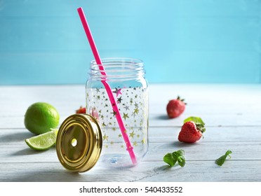 Empty Mason Jar With Strawberries And Lime On Wooden Table